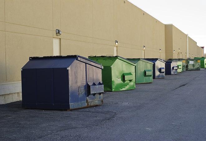 a compact construction dumpster being emptied by a waste disposal truck in Anderson Island, WA